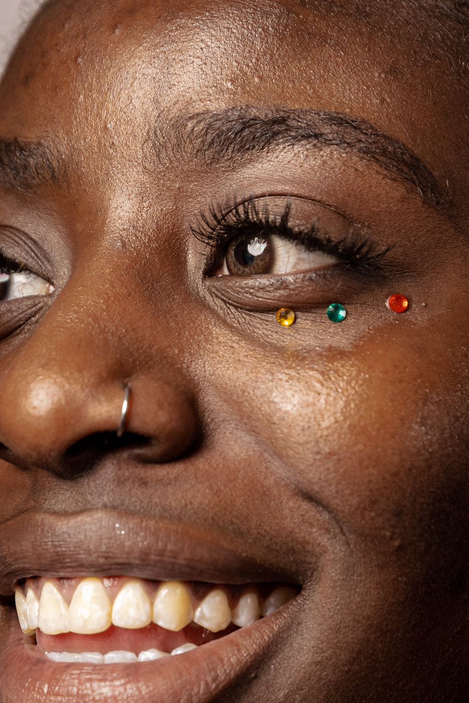 Closeup of Smiling Woman with Gems Under Her Eye